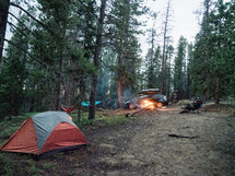 campfire and tents at a campsite 
