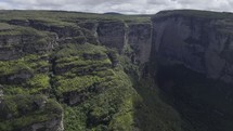 Drone slowly lowers in canyon with Fumaça waterfall