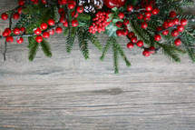 Christmas background with winter greenery and red berries border