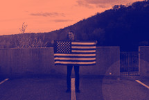 a man holding the edge of an American flag 