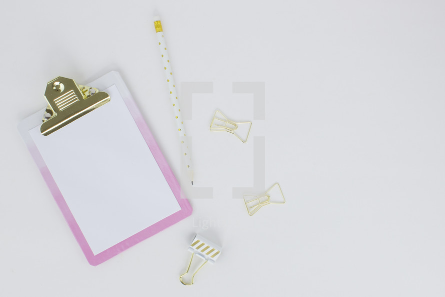 clipboard, blank paper, pencil, paper clips, pink, gold, polka dot 