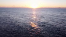 Drone panning from ocean to beautiful sunset over the pacific ocean.