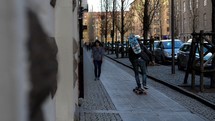 man skateboarding on a sidewalk in Gothenburg, Sweden
