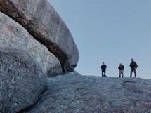 men standing on a mountaintop 