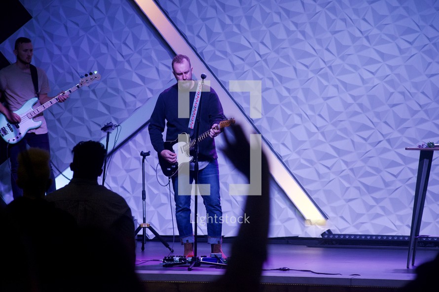 guitarist on stage at a worship service 