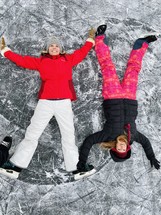 making snow angels in the ice wearing ice skates 