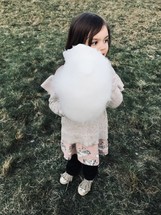 toddler girl with cotton candy 
