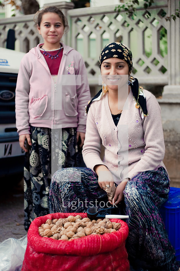 Mother and daughter selling walnuts