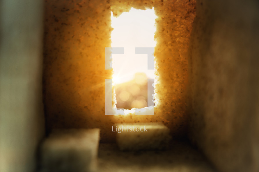 Empty tomb with sun rays beaming in