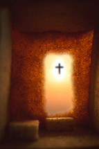Empty tomb with cross visible outside