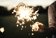 hand holding out a sparkler 