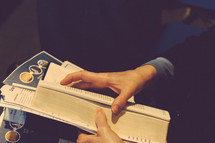 A Bible in a lap at a worship service 