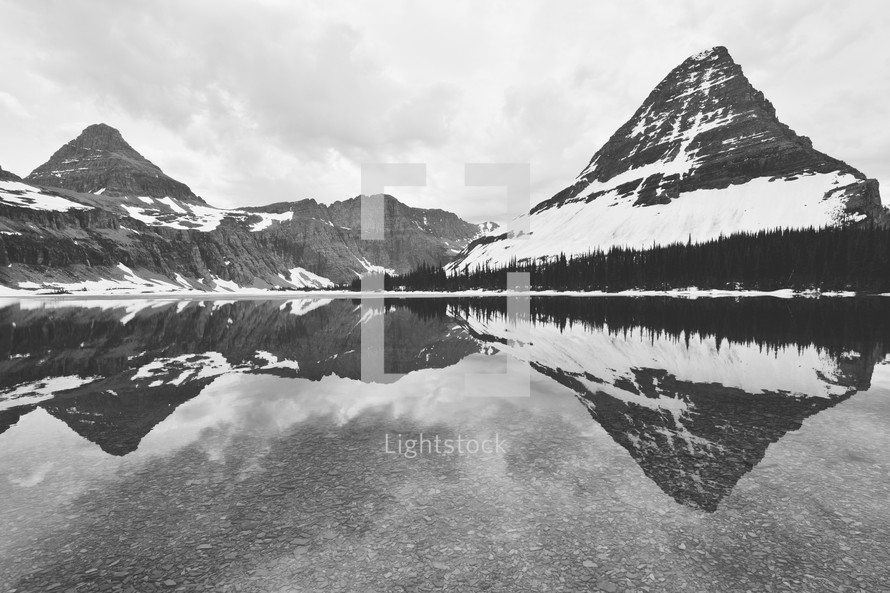 reflection on mountain peaks on water 