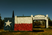Texas flag mural on an abandoned gas station.