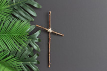 palm fronds and cross on a gray background 
