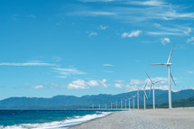 wind turbines along a shore 