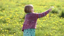 girl child picking flowers outdoors