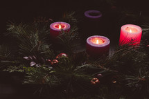 Rustic advent wreath with three candles lit