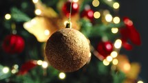 Christmas rotating golden color ball against the tree