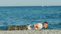 Soldier does push ups on the beach