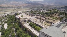 Aerial view of the hilltop Castle of Gjirokastra, Albania. Sprawling cityscape 