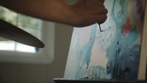 artist painting a canvas 