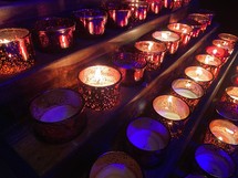 prayer candles in rows