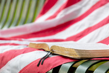 American flag and Bible on bench