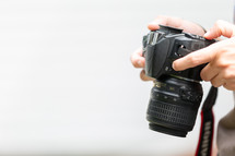 hand holding a camera with white background