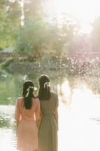 girls standing by a lake shore 