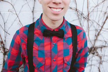 a young man in a bowtie and suspenders 