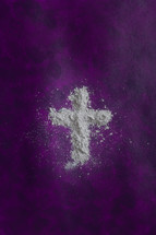 ashes in the shape of a cross on purple 