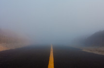 A highway leading into fog.