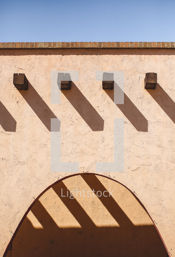 Roof and arch of a stucco house.