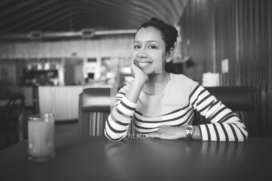 A woman sitting in a coffee shop.
