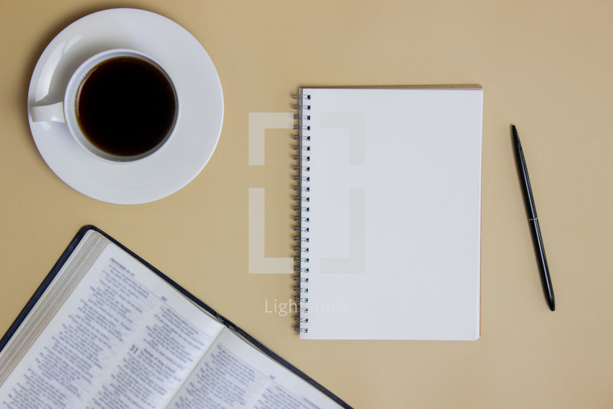 open Bible, coffee cup, and journal 