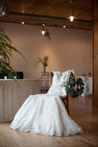 wedding dress in a chair in a reception hall 