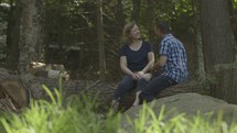 Middle aged married couple talking in the woods enjoying nature