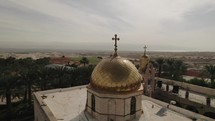 Drone Aerial orbit around an Israeli church temple with a cross Steeple Crucifix Aerial Middle East Holy Land