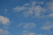 puffy clouds in a blue sky 