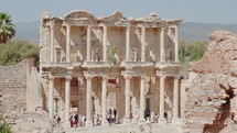 Tourists visiting Celsus Library in ancient city Ephesus, Anatolia in Selcuk, Turkey. Slow motion steadicam shot