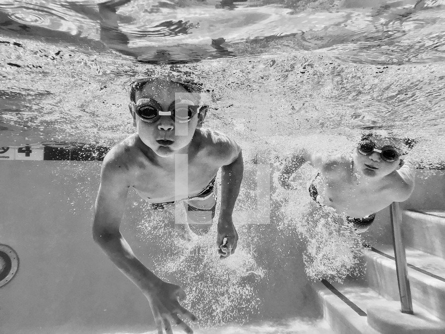 boys swimming in a pool 