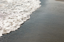 tide washing onto the beach 
