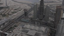 Cinematc, slow motion drone, aeiral , sky view of downtown Dubai buildings and skyscrapers from the Burj Khalifa in the middle eastern country of United Arab Emirates in cinematic slow motion.