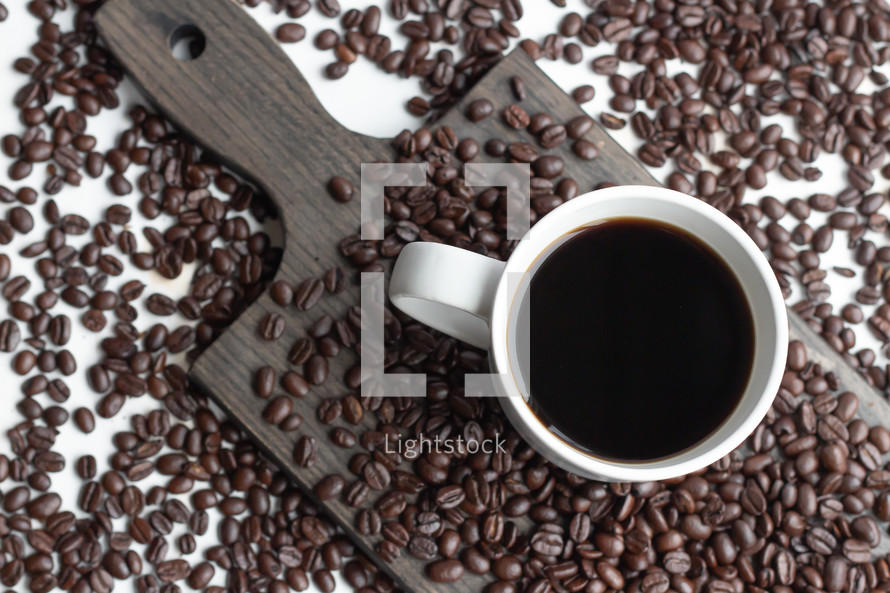 coffee and coffee beans on cutting board 