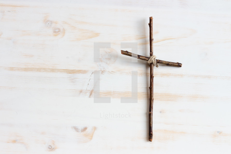 simple cross on a white wood background 