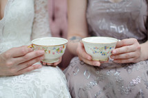 bride and bridesmaid with tea cups 