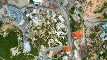 Aerial top down view of typical houses excavated and shaped into the mountains in Cappadocia region, Nevsehir, Turkey.
