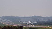 Commercial airplane landing on a runway.