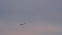 Far away view of a commercial airplane flying,